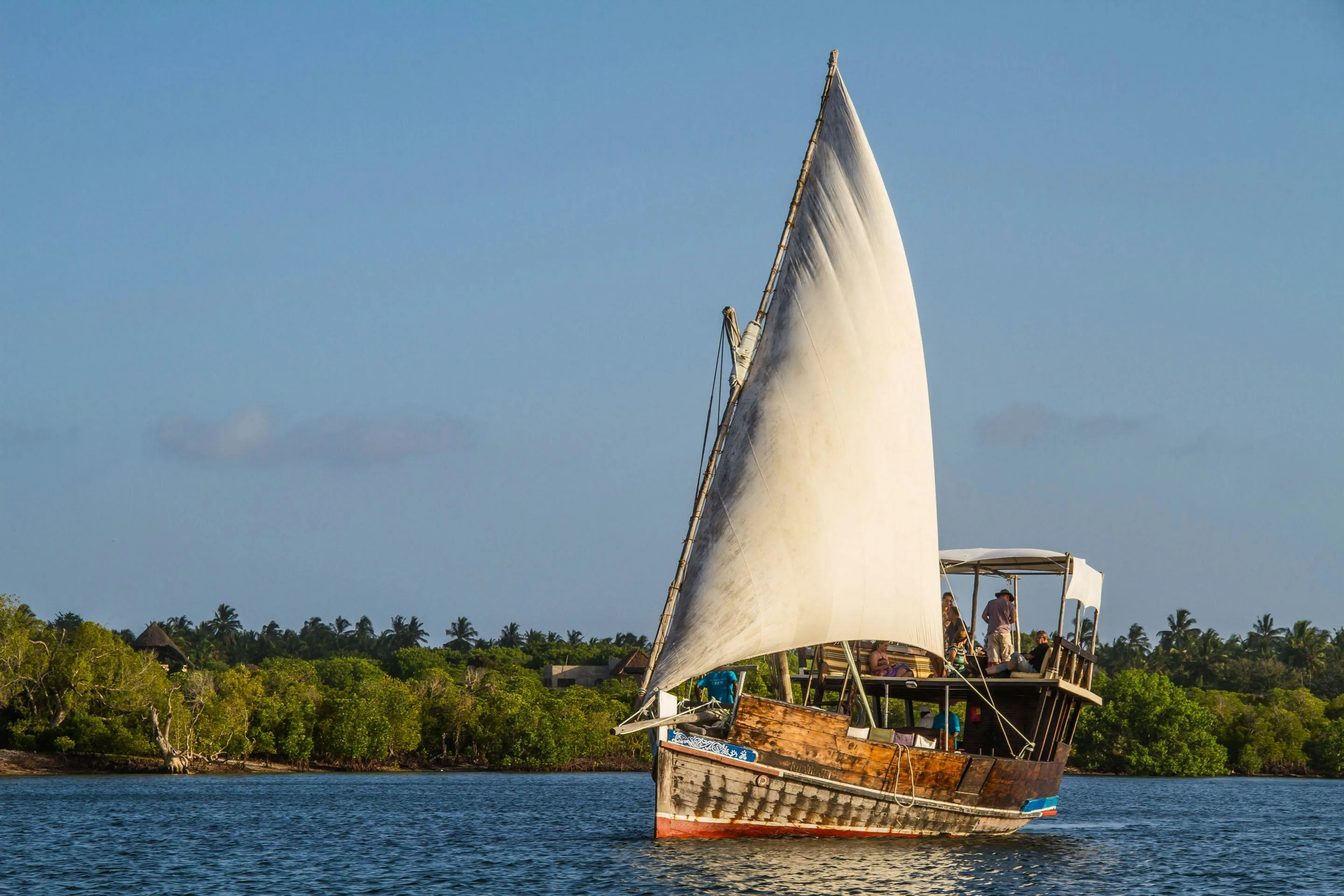 Travellers boarding a traditional dhow at Mida Creek Watamu